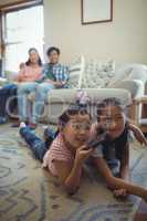 Family watching television together in living room