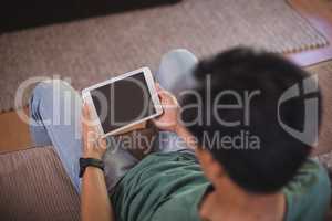 Man using digital tablet in living room