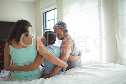 Happy family having fun on bed in bed room