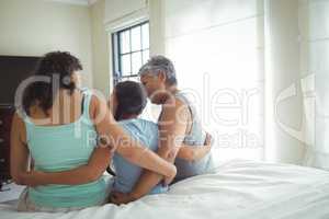 Happy family having fun on bed in bed room