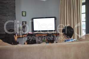 Family watching television together in living room