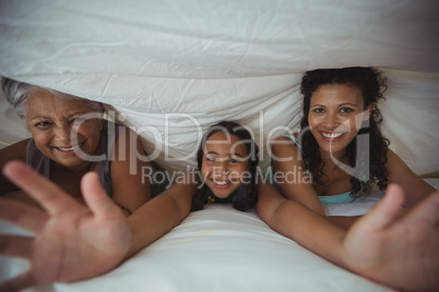 Happy family lying on bed in bed room