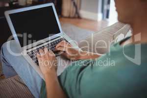 Man using laptop in living room