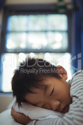 Boy sleeping on the bed in bed room