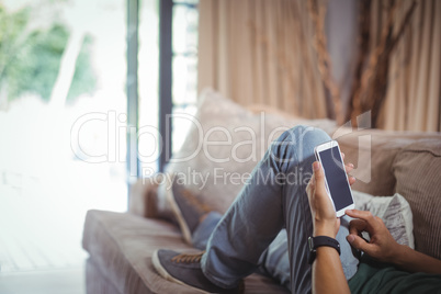 Man using mobile phone in living room