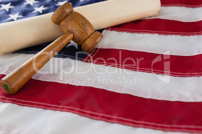 Gavel and rolled-up document arranged on American flag