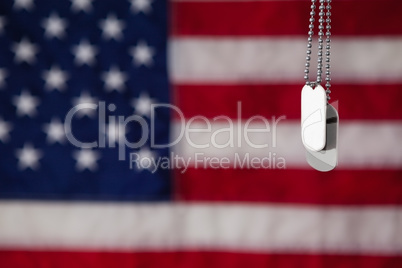 Dog tag hanging against American flag background
