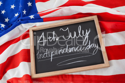 American flag and slate with text 4th july independence day