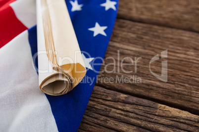 American flag with rolled-up of constitution document