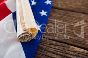 American flag with rolled-up of constitution document