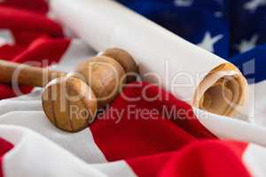 Gavel and rolled-up document arranged on American flag