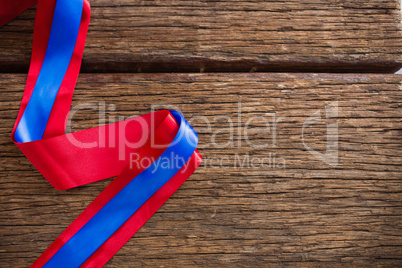 Red and blue ribbon on wooden table Red and blue ribbon on wooden table