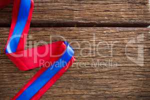 Red and blue ribbon on wooden table