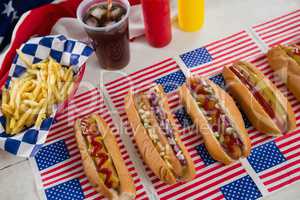 American flag and hot dogs on wooden table