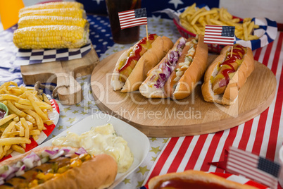 Burgers and corn cob on wooden table with 4th july theme