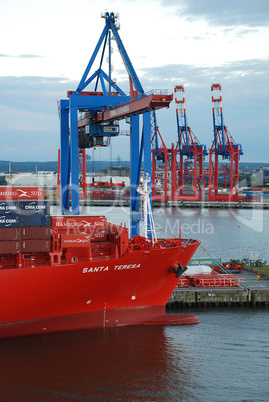 cranes and a container ship in the harbor of Hamburg, Germany