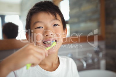 Boy brushing his teeth in bathroom