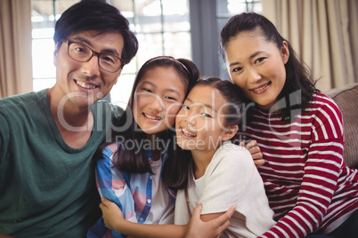 Smiling family relaxing on sofa in living room