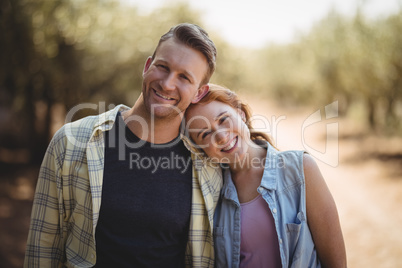 Young couple standing at olive farm on sunny day