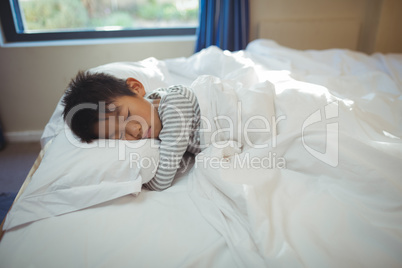 Boy sleeping on the bed in bed room