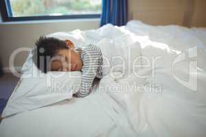 Boy sleeping on the bed in bed room