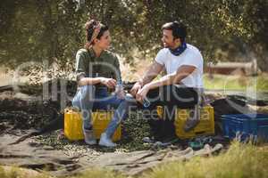 Young couple talking while sitting at olive farm