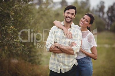 Portrait of young couple standing at olive farm