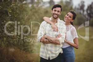 Portrait of young couple standing at olive farm