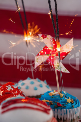 Close-up of burning sparkler on decorated cupcakes