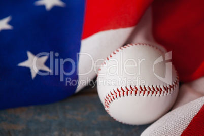 Baseball and American flag on wooden table