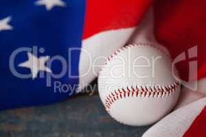 Baseball and American flag on wooden table