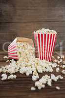 Scattered popcorn on wooden table