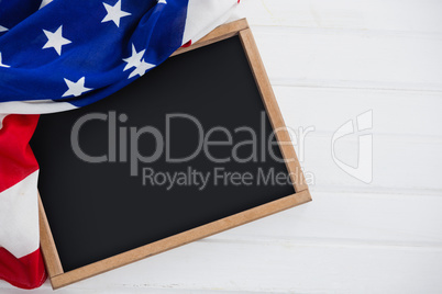 American flag and slate on wooden table