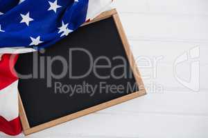 American flag and slate on wooden table