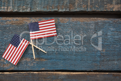 Two American flags on a wooden table