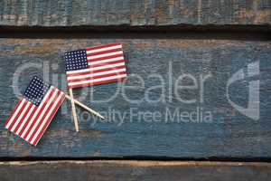 Two American flags on a wooden table