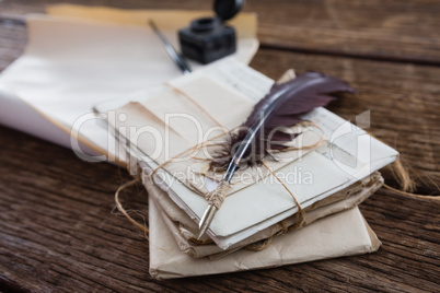 Quill feather with legal documents arranged on table