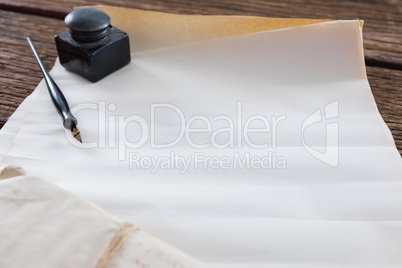 Ink pot, ink pen and legal documents arranged on table