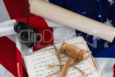 Gavel with tied up documents arranged on American flag