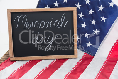 American flag and slate with text memorial day