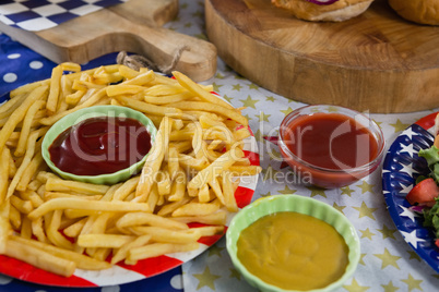 French fries on wooden table with 4th july theme