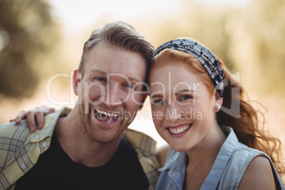 Portrait of cheerful young couple at olive farm