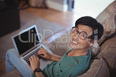 Man using laptop in living room