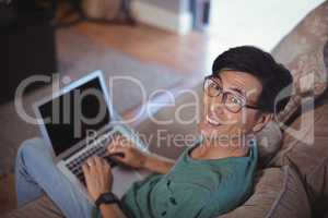 Man using laptop in living room