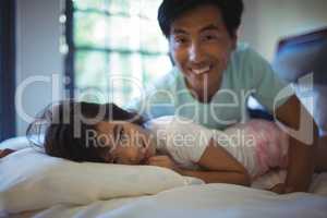 Father and daughter having fun on bed in bed room