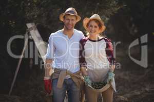 Happy young couple collecting olives at farm