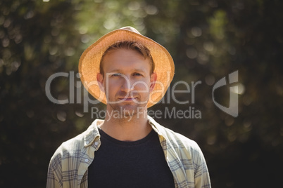 Handsome young man wearing hat on sunny day at olive farm