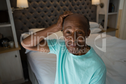 Portrait of smiling senior man sitting at home