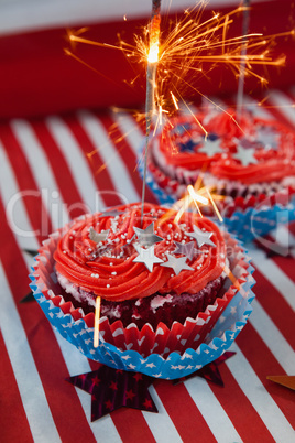 Burning sparkler on decorated cupcakes