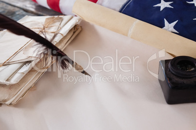 Quill feather and ink pot with legal documents arranged on table